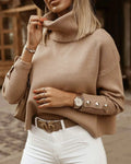 Women's high neck knit sweater with button details on the sleeves
