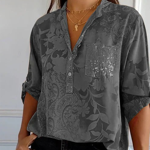 Women's blouse with collar, patterned surface and three-quarter sleeves